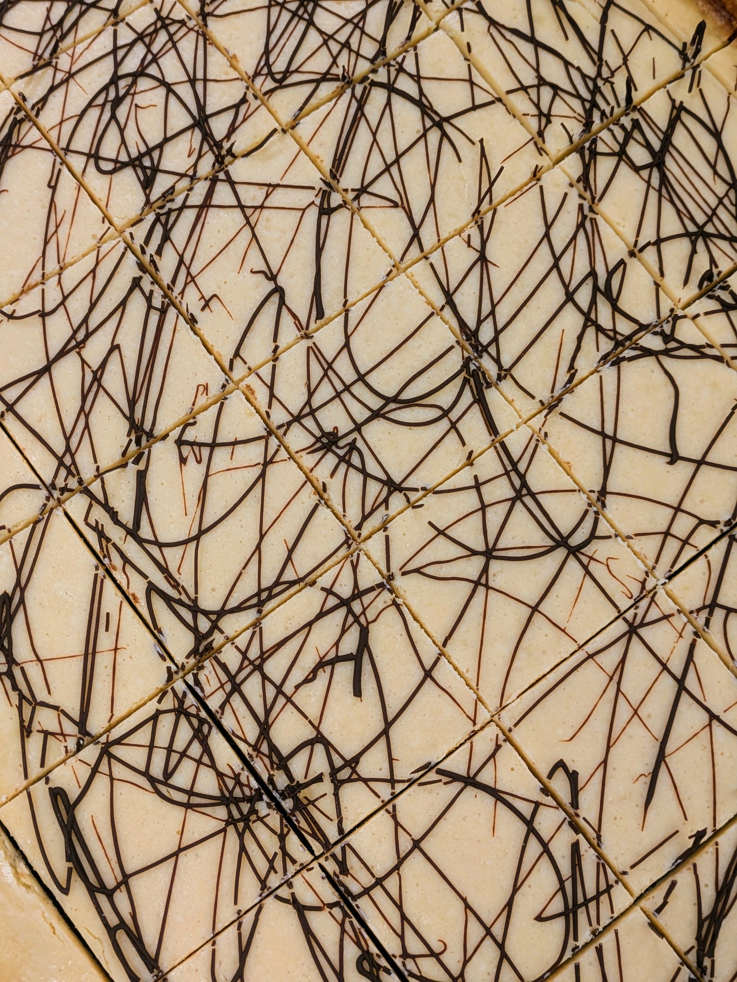 Irish Cream Cheese Brownie cut in pan for St. Patrick's Day