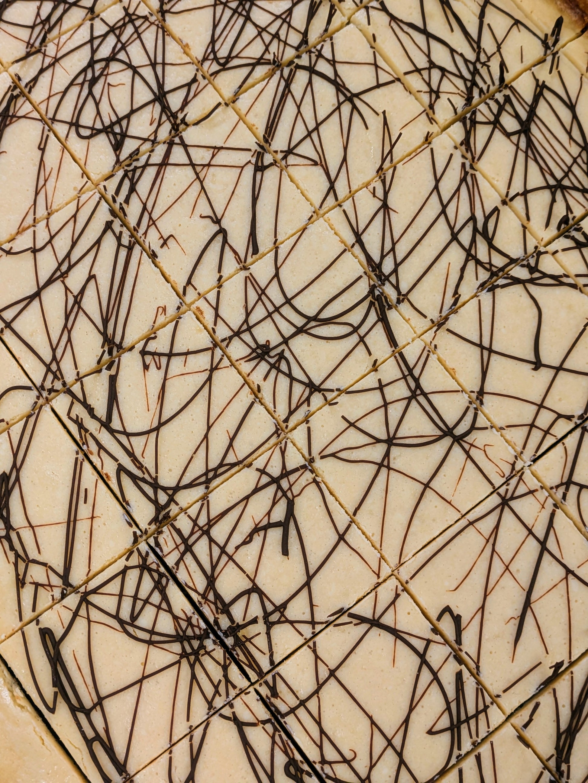 Irish Cream Cheese Brownie cut in pan for St. Patrick's Day