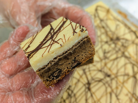 Irish Cream Cheese Brownie in hand close up for St. Patrick's Day