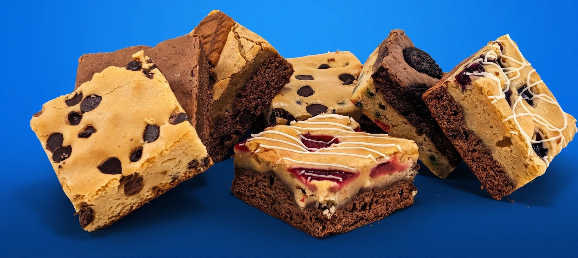 Large Buckabee brookies fanned out showing a variety of flavors including chocolate chip, strawberry white chocolate drizzle, and blueberry