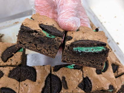 Mint Cookies & Cream Brownie in hand close up for St. Patrick's Day