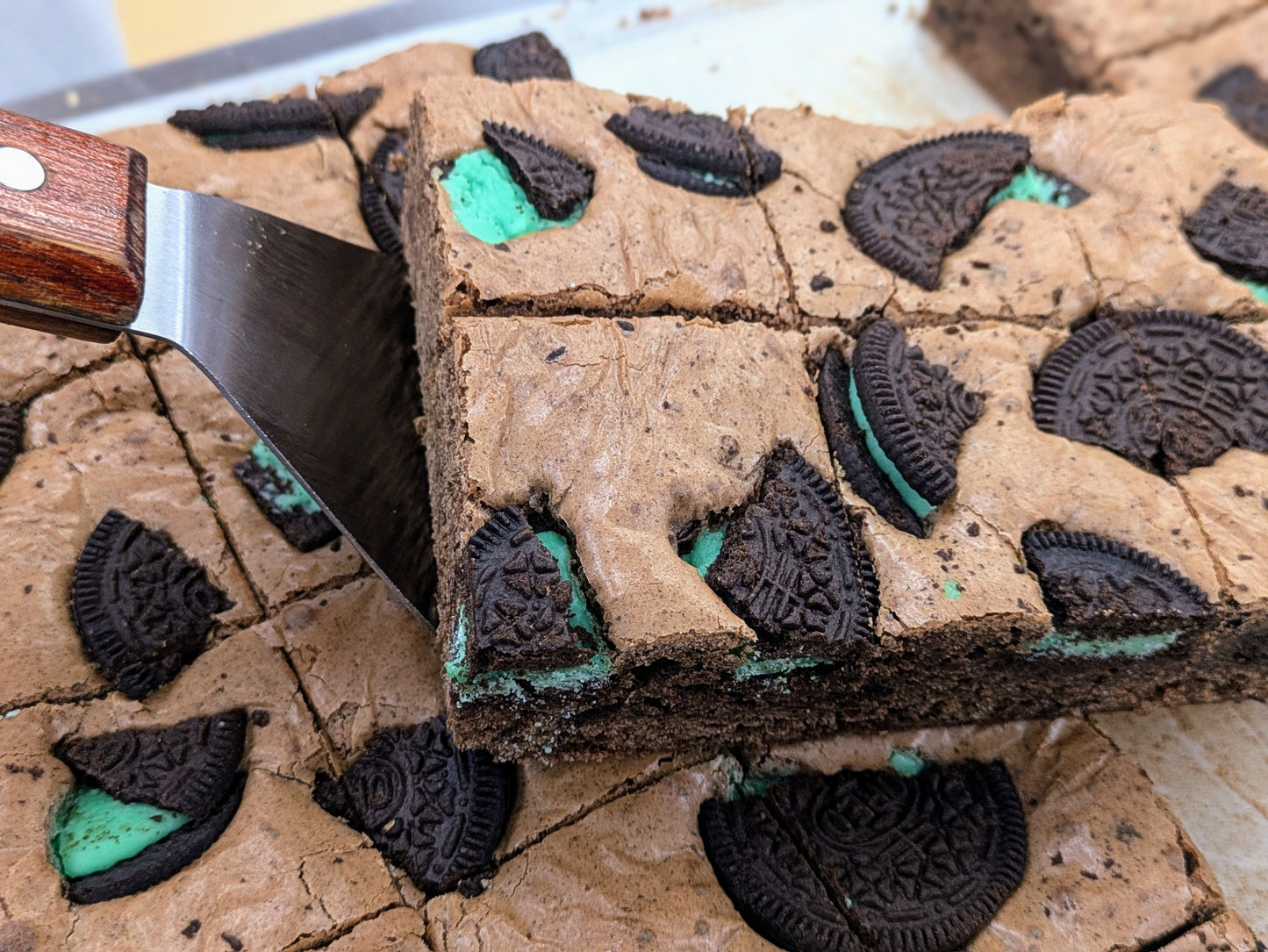 Mint Cookies & Cream Brownie in pan stacked for St. Patrick's Day