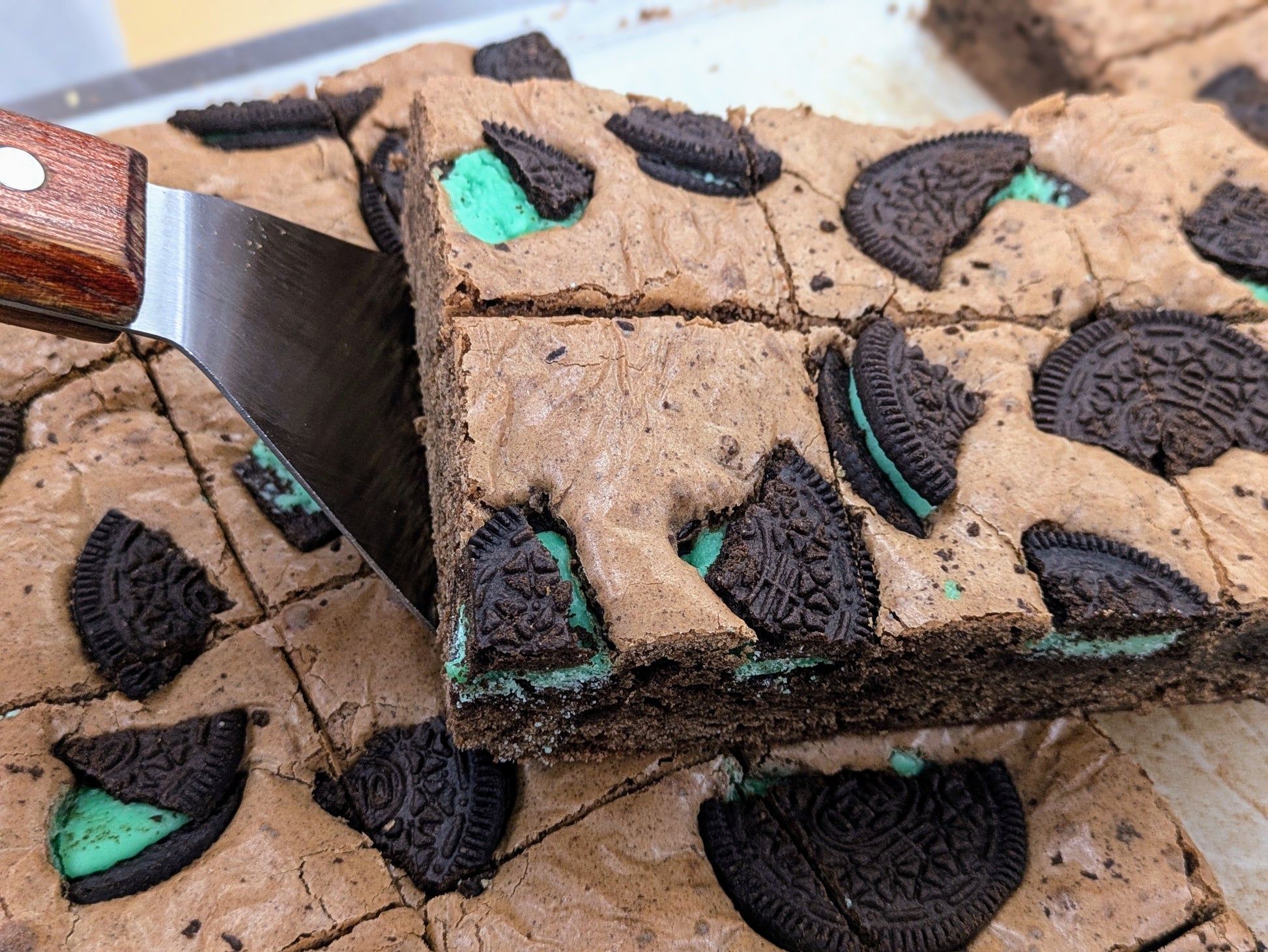 Mint Cookies & Cream Brownie in pan stacked for St. Patrick's Day