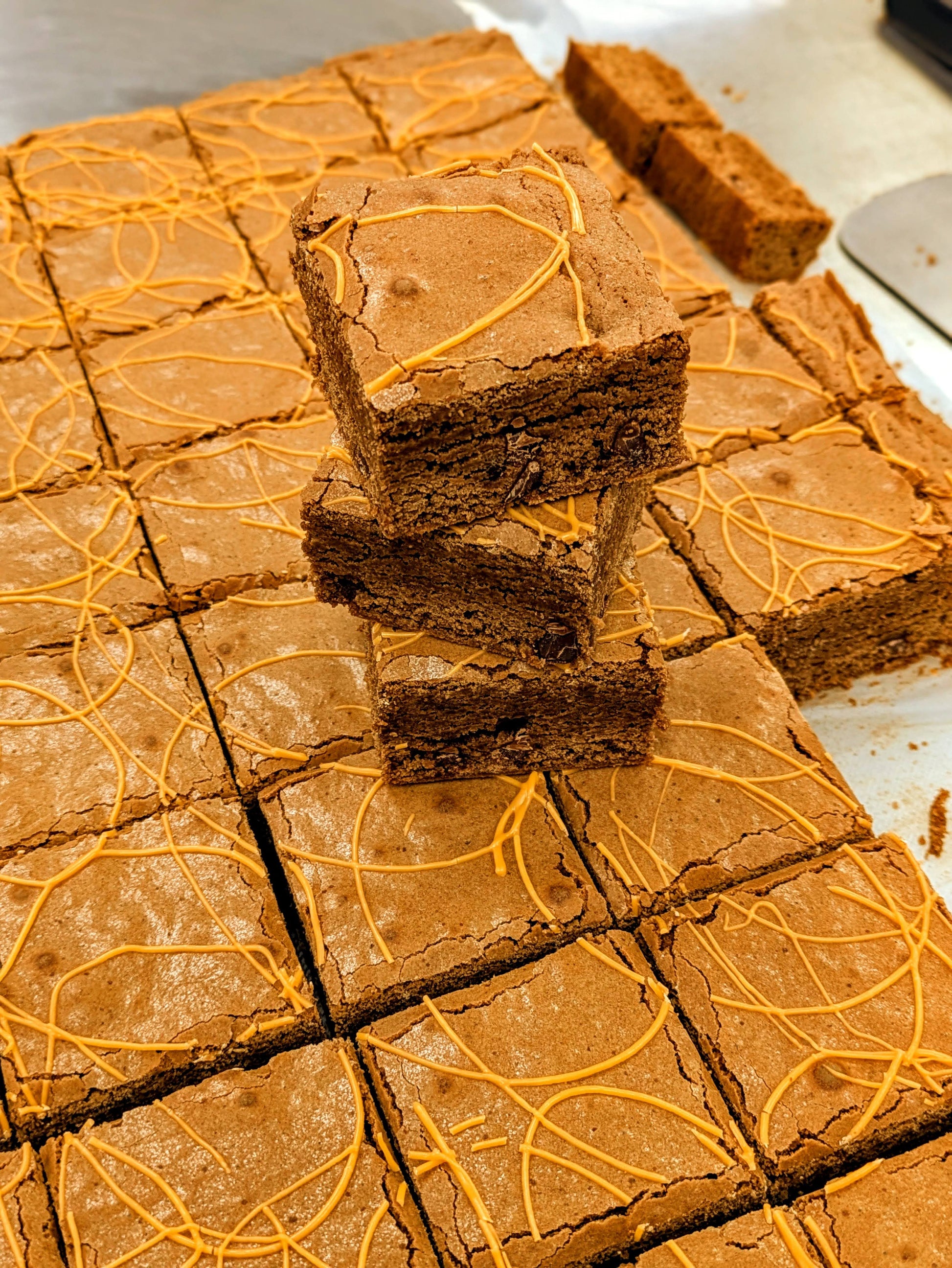 Orange Fudgy Chocolate Brownie stacked in pan