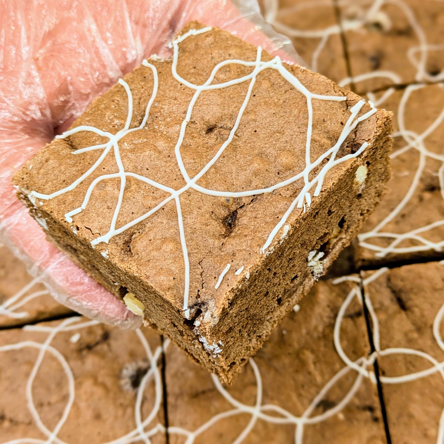 Root Beer Float Brownie Large in hand over pan