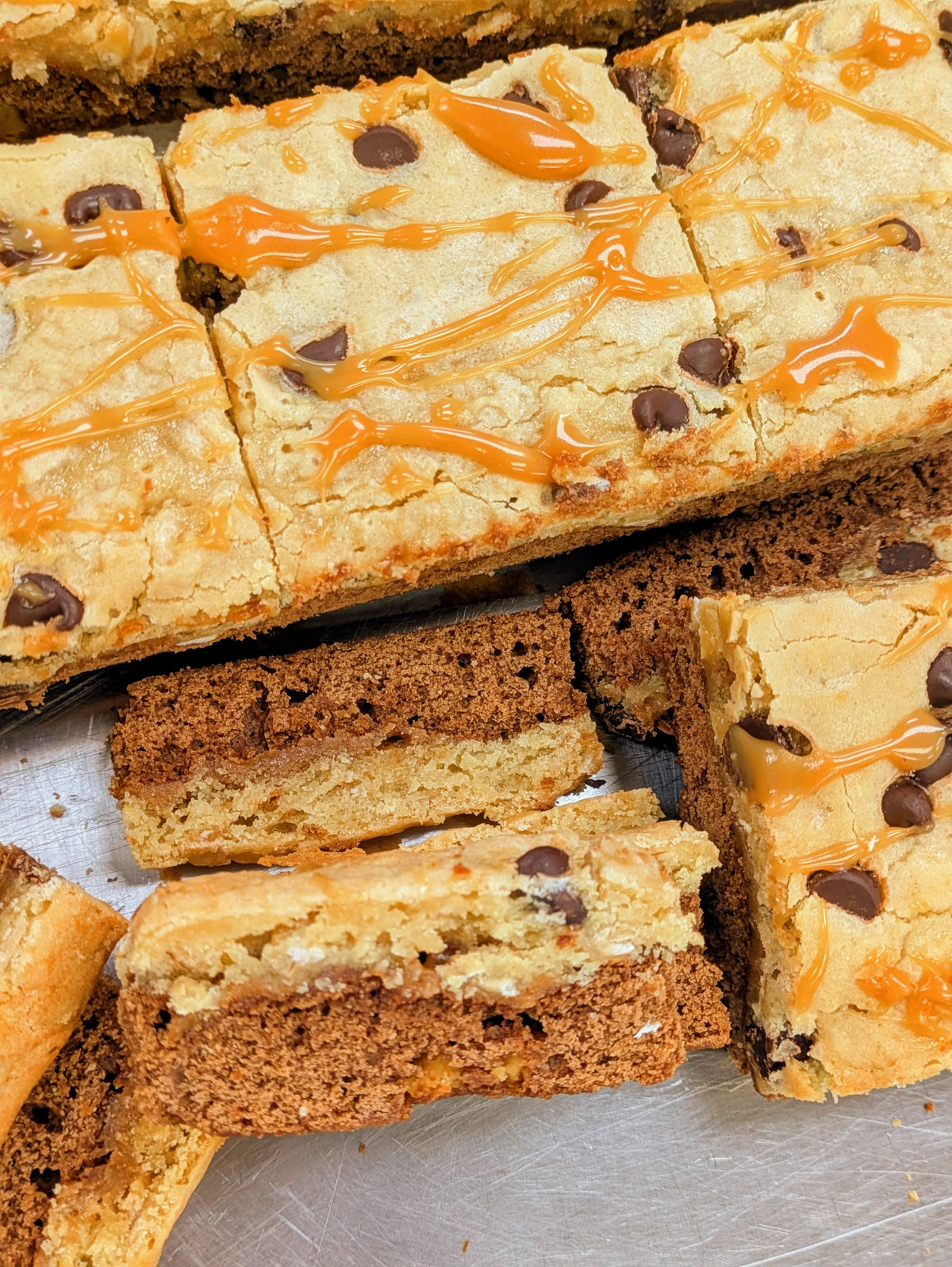 Salted Caramel Oatmeal Brookie square with caramel drizzle among more layered brookies.