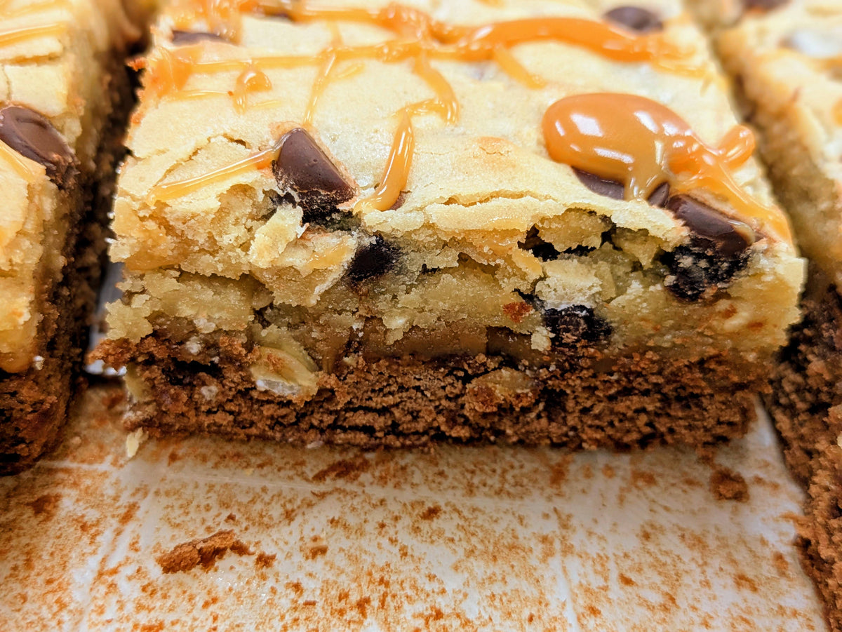 Close-up of a Salted Caramel Oatmeal Brookie showing its oatmeal blondie, caramel, and fudgy chocolate layers.