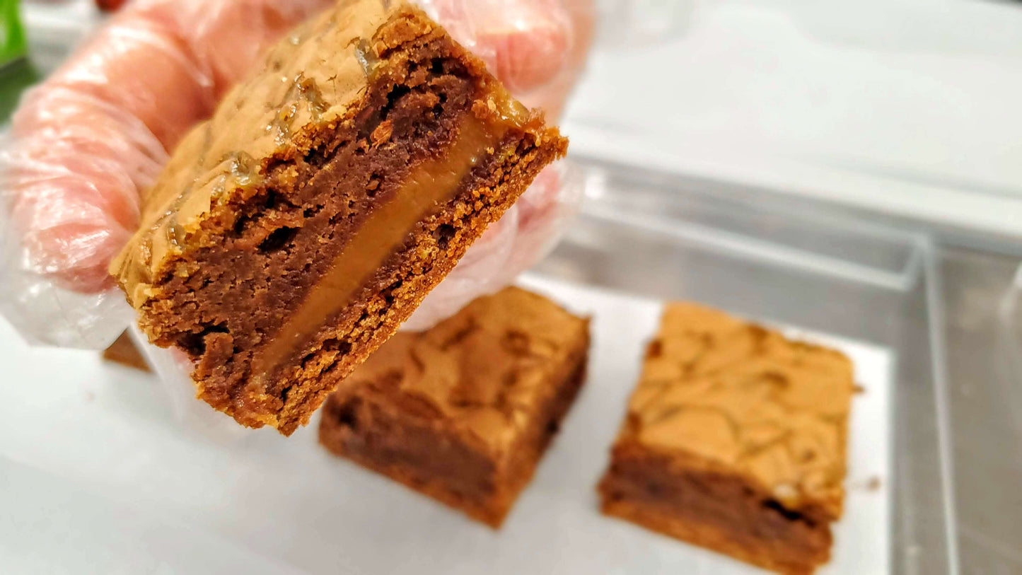 Salted Caramel Brownie close up in hand