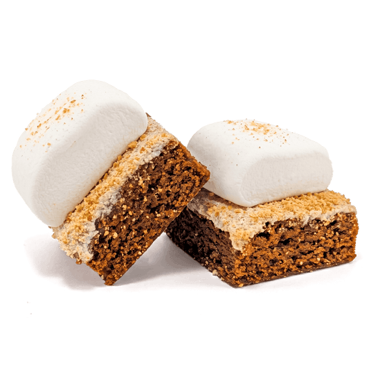 Two Buckabee S'mores Brownies topped with oversized marshmallows and crushed graham crackers, showing fudgy chocolate brownie interior