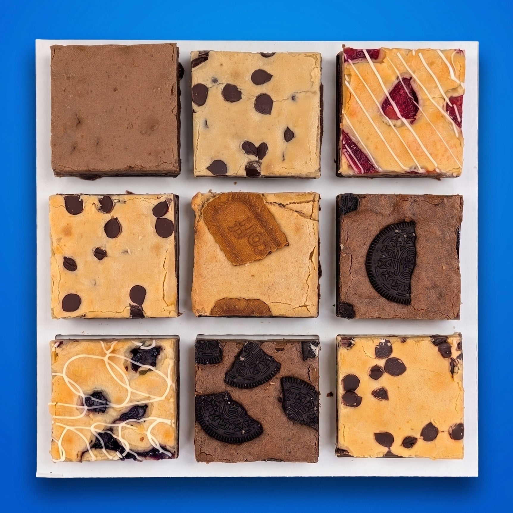 Overhead flat lay of nine large brownies and brookies in a Build Your Own Box, featuring flavors like Oreo brownie, chocolate chip