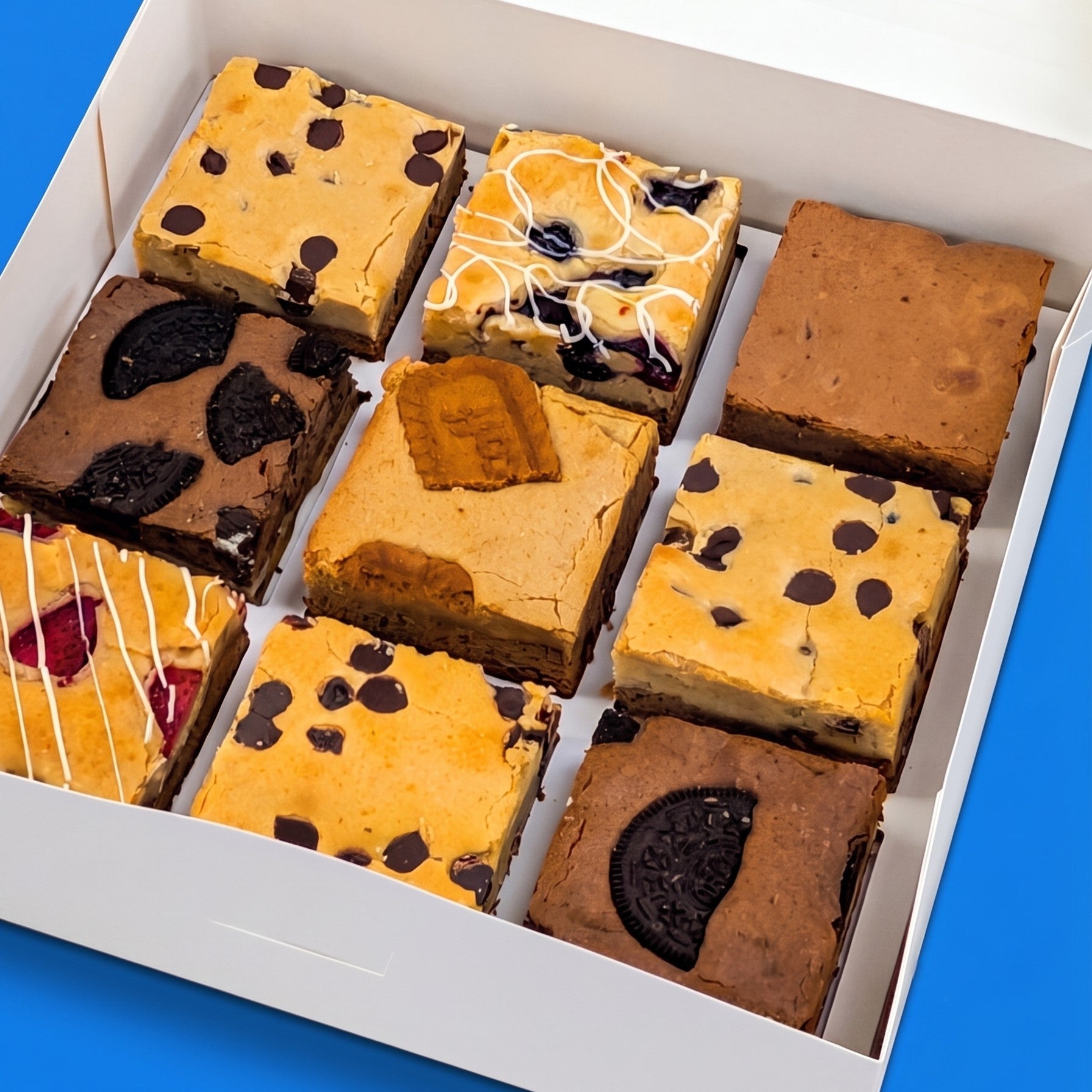 Angled close-up of an open Build Your Own Large Box packed with nine large brownies and brookies including Oreo, biscoff, blueberry, and chocolate chip varieties