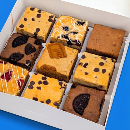 Angled close-up of an open Build Your Own Large Box packed with nine large brownies and brookies including Oreo, biscoff, blueberry, and chocolate chip varieties