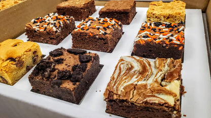 Assorted brownies with different toppings in a box