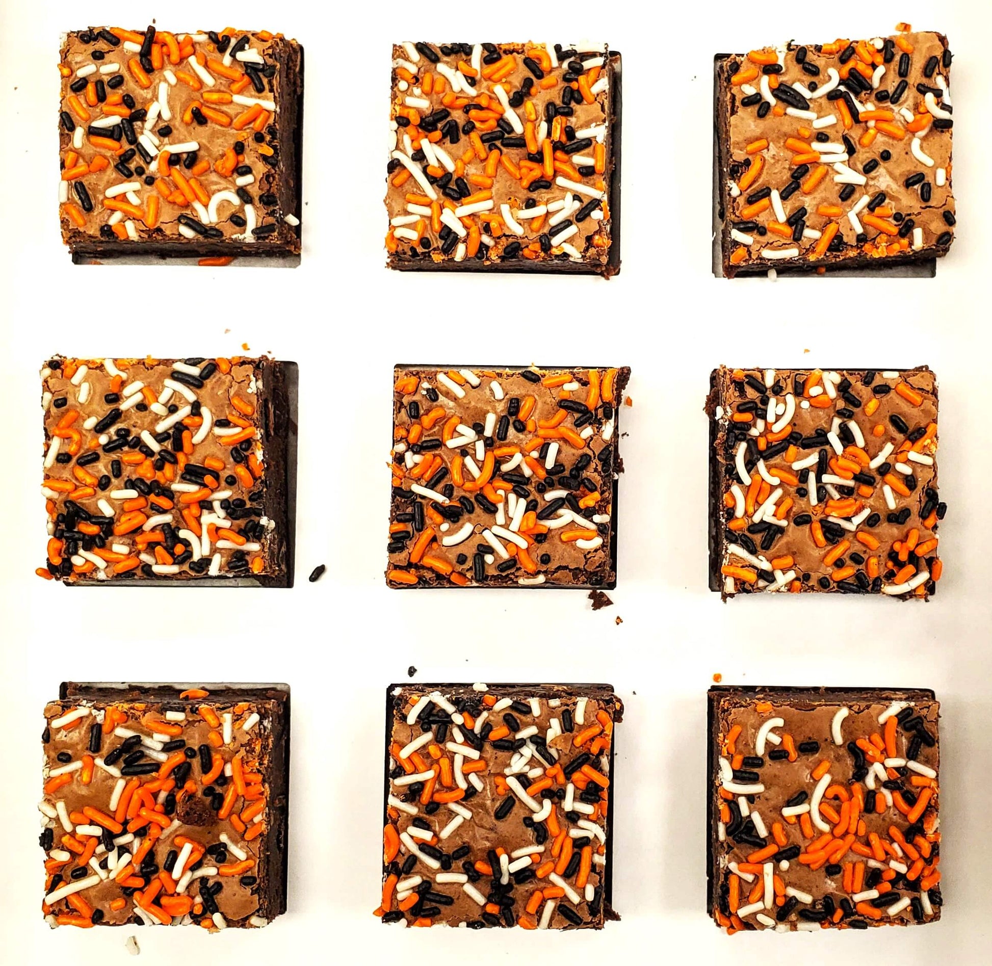 Nine Who Dey brownies with sprinkles arranged in a 3x3 grid on a white background. 
