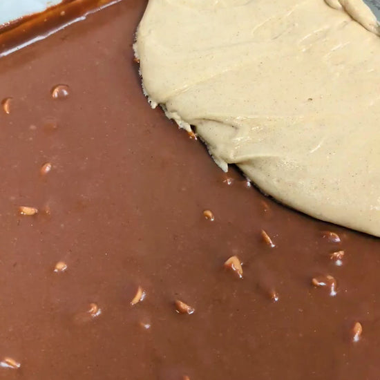 Butterscotch Cinnamon Brookie ready for oven. Made of two layers, bottom fudgy with butterscotch chips, top layer soft blondie with cinnamon.