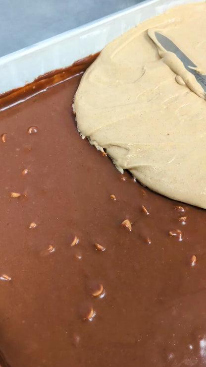 Butterscotch Cinnamon Brookie ready for oven. Made of two layers, bottom fudgy with butterscotch chips, top layer soft blondie with cinnamon.